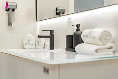 a bathroom with a sink with towels and a mirror at Luxury 2BR in Dubai Marina Balcony, Views, Walk to Metro & Tram in Dubai