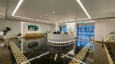 a large living room with a bar in the middle at Luxury 2BR in Dubai Marina Balcony, Views, Walk to Metro & Tram in Dubai