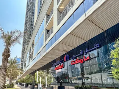 a building with a sign on the side of it at LUX 52 42 Deluxe Marina View Suite 3 in Dubai