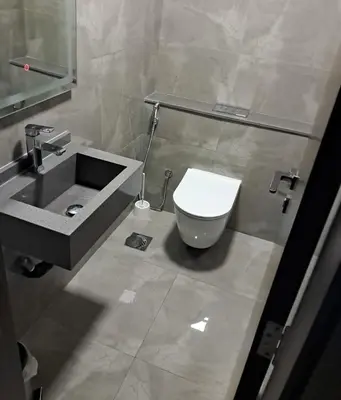 a bathroom with a toilet and a sink at Majestic Retreat - 1BR Dubai in Dubai