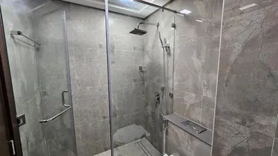 a bathroom with a shower with a glass door at Southside Spacious & Sleek - 2BR in Dubai