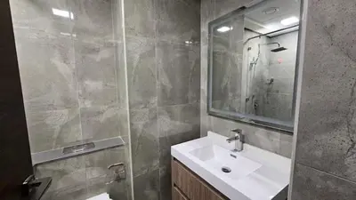 a bathroom with a sink and a mirror at Studio Luxe Dubai South in Dubai
