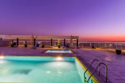 a swimming pool on the roof of a building at The Executive Nest -1BR in Dubai in Dubai