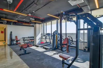 a gym with several treadmills and tread machines at The Executive Nest -1BR in Dubai in Dubai