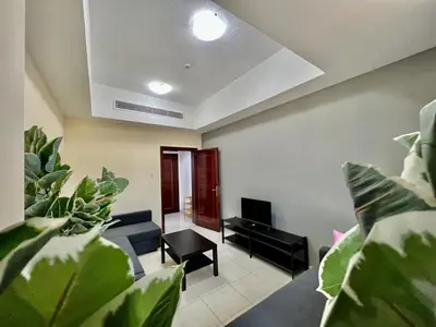 a living room with a couch and some plants at Close to The World Trade Center and DIFC in Dubai