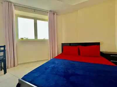 a red and blue bed in a room with a window at Close to The World Trade Center and DIFC in Dubai