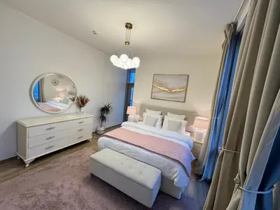 a bedroom with a large bed and a mirror at Luxury 2BR Canal front & Burj Khalifa views- High Floor in Dubai