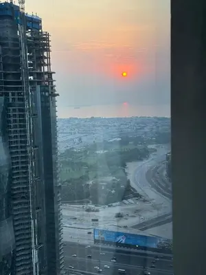 a view of the sunset from a building at Luxury 2BR Canal front & Burj Khalifa views- High Floor in Dubai
