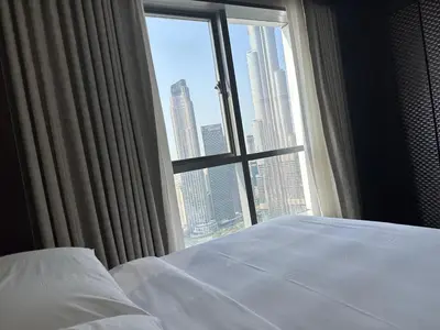 a bedroom with a window with a view of a city at A&S Downtown Dubai in Dubai