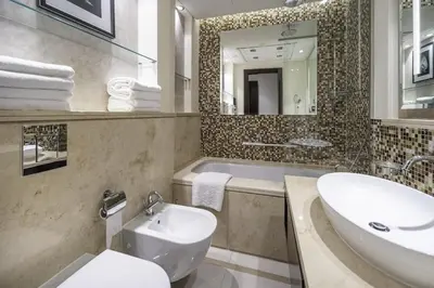 a bathroom with a sink and a toilet and a tub at A&S Downtown Dubai in Dubai