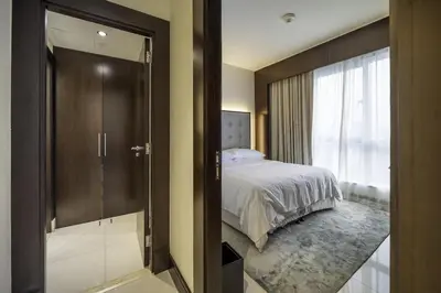 a bedroom with a bed and a sliding glass door at A&S Downtown Dubai in Dubai