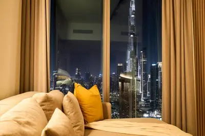 a room with a window with a view of a city at Luxury Apt 2BR with full burj khalifa view in Dubai