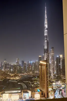 a city skyline at night with the tallest building at Luxury Apt 2BR with full burj khalifa view in Dubai