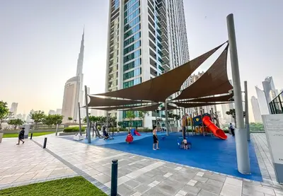 a playground with people playing on a blue carpet at Luxury Apt 2BR with full burj khalifa view in Dubai