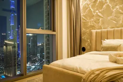 a bedroom with a large window with a city skyline at Luxury Apt 2BR with full burj khalifa view in Dubai