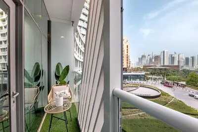 a balcony with a view of a city at Luxury Palm Studio - Skyline Views - Rooftop Pool & Beach Access in Dubai