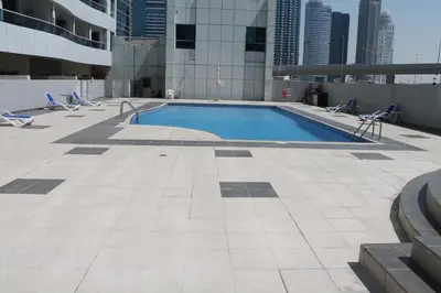 a swimming pool on the roof of a building at Studio apartment walking distance to metro and beach in Marina in Dubai