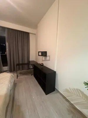 a bedroom with a bed and a desk in it at Azizi Riviera Luxury Studio with Grand Balcony in Dubai