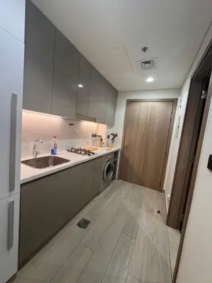 a kitchen with a sink and a washing machine at Azizi Riviera Luxury Studio with Grand Balcony in Dubai