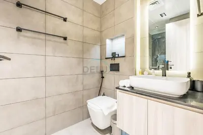 a bathroom with a sink and a toilet at Just Steps Away from Circle Mall, Right Beside a Park, Near Restaurants, Conveniently Close to a Bus Stop, Lumina Vista Residences, Jumeirah Village Circle by Deluxe Holiday Homes in Dubai