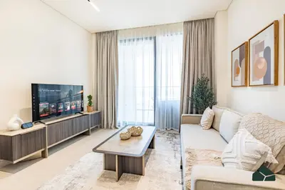 a living room with a couch and a tv at Luxury Studio with Canal View and Jacuzzi by BMS in Dubai