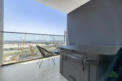a kitchen with a large window with a view at Luxury Studio with Canal View and Jacuzzi by BMS in Dubai