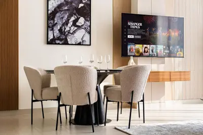 a dining room with a table and chairs at SettlerHomes - Elite 2BR With Private Jacuzzi Oasis in Dubai