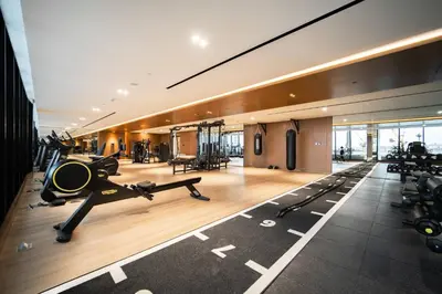 a gym with treadmills and exercise equipment in a building at SettlerHomes - Elite 2BR With Private Jacuzzi Oasis in Dubai
