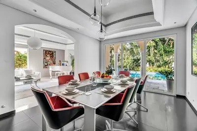 a dining room with a table and chairs at DAYF-NIL Lux 5-BR Villa with Pool & Piano - Green Community in Dubai