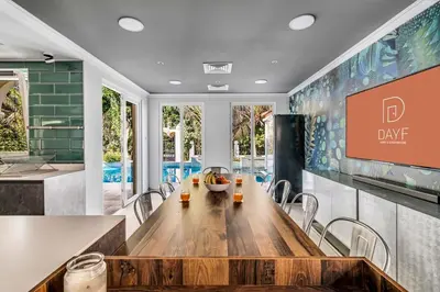 a dining room with a long table and chairs at DAYF-NIL Lux 5-BR Villa with Pool & Piano - Green Community in Dubai