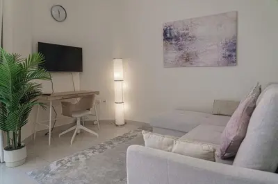 a living room with a couch and a table at Modern 2BR Apartment at JBR in Dubai