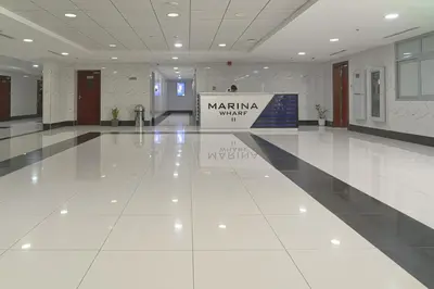 a large lobby with a white floor and a sign at Modern 2BR Apartment at JBR in Dubai