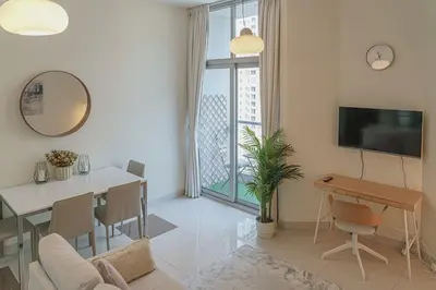 a living room with a table and a dining room at Modern 2BR Apartment at JBR in Dubai