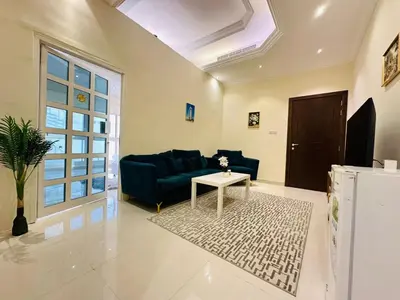 a living room with a blue couch and a table at Dubai Al Barsha Villa Fully Furnished Luxury Private Master Room Ensuite Huge Space Deluxe in Dubai