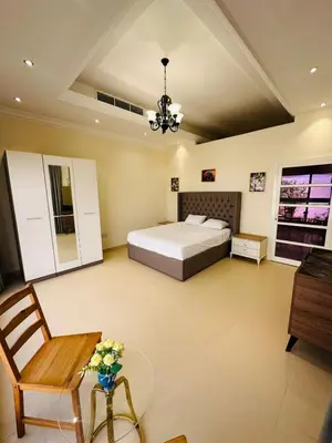 a bedroom with a bed and a table and a chair at Dubai Al Barsha Villa Fully Furnished Luxury Private Master Room Ensuite Huge Space Deluxe in Dubai