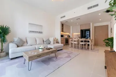 a living room with a couch and a table at FAM Living - Elegant 2BR with Park & Creek Panorama in Dubai