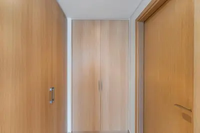 a closet with wooden doors in a room at FAM Living - Elegant 2BR with Park & Creek Panorama in Dubai