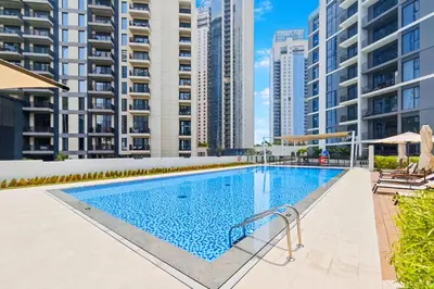 a swimming pool in a building with tall buildings at FAM Living - Elegant 2BR with Park & Creek Panorama in Dubai