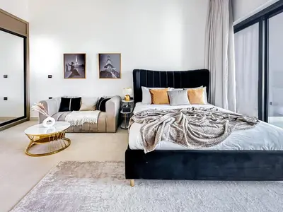 a bedroom with a large bed and a couch at Skyline Views Chic 1BR with Canal Vibes in Dubai