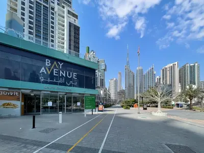 a shopping center in a city with tall buildings at Skyline Views Chic 1BR with Canal Vibes in Dubai