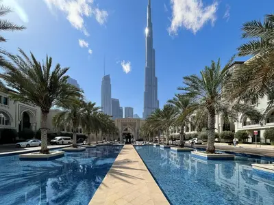 a view of the burj khalifa from the dubai mall with trees at Skyline Views Chic 1BR with Canal Vibes in Dubai