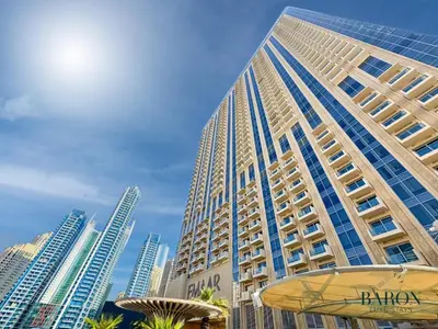 a tall building in front of a city at The Serene in Dubai