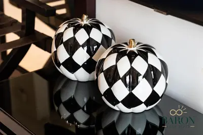 two black and white pumpkins sitting on a shelf at The Serene in Dubai