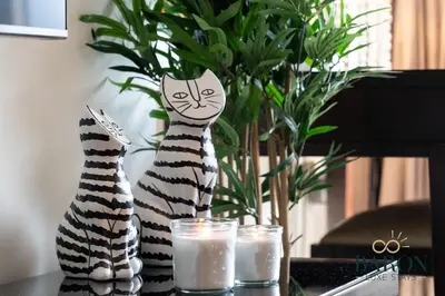 two statues of cats sitting on a table with candles at The Serene in Dubai