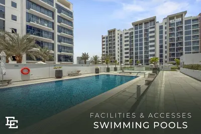 a swimming pool in front of some buildings at Elite Escape - Boho Getaway in Azizi Riviera 16 in Dubai
