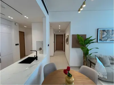 a kitchen and living room with a wooden table in a room at 2 Bed, Private Pool, Big Terrace, Solysian Stay in Dubai