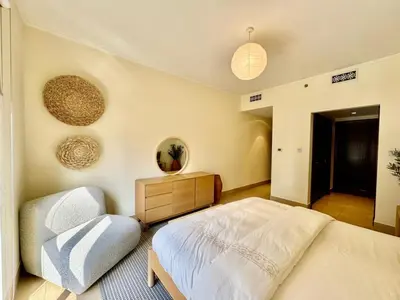 a bedroom with a bed and a dresser in it at Only family Walking distance to Dubai Mall in Dubai