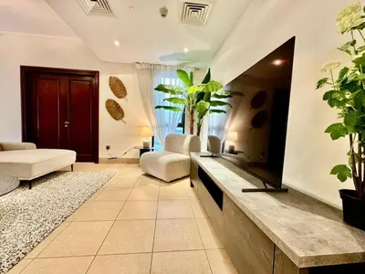 a living room with a large mirror and plants at Only family Walking distance to Dubai Mall in Dubai