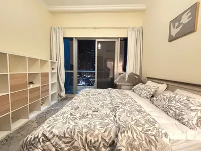 a bedroom with a large bed and a large window at Premium 1BR in Dubai Marina King Bed, Marina View, Near JBR, Beach & Vibrant Nightlife in Dubai