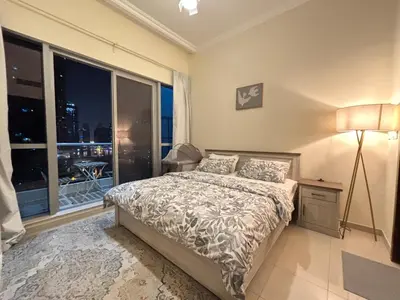 a bedroom with a bed and a large window at Premium 1BR in Dubai Marina King Bed, Marina View, Near JBR, Beach & Vibrant Nightlife in Dubai